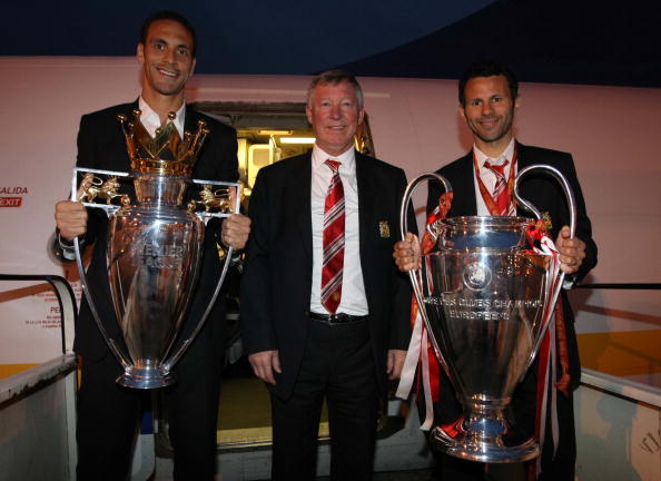 Sir Alex Ferguson, Ryan Giggs and Rio Ferdinand of Manchester United pose with the UEFA Champions League trophy and the FA Barclays Premier League trophy 2008