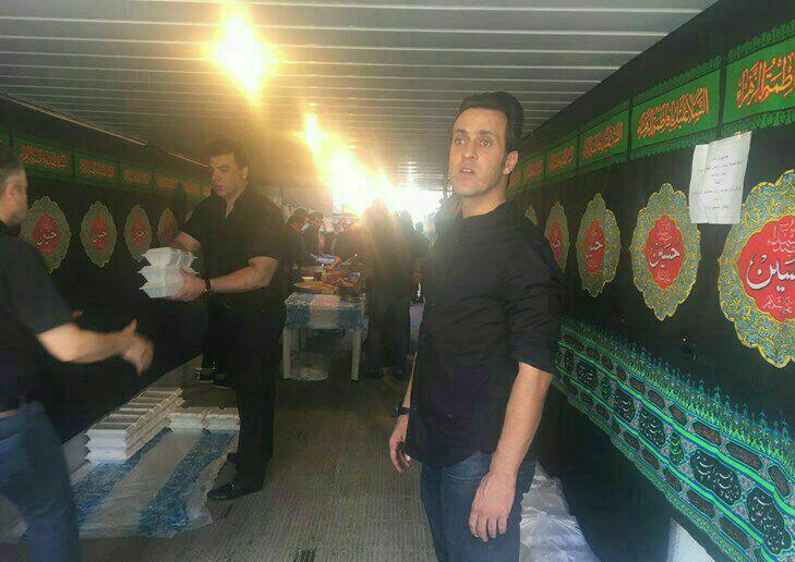 علی کریمی در حال پخش نذری عاشورا (عکس)